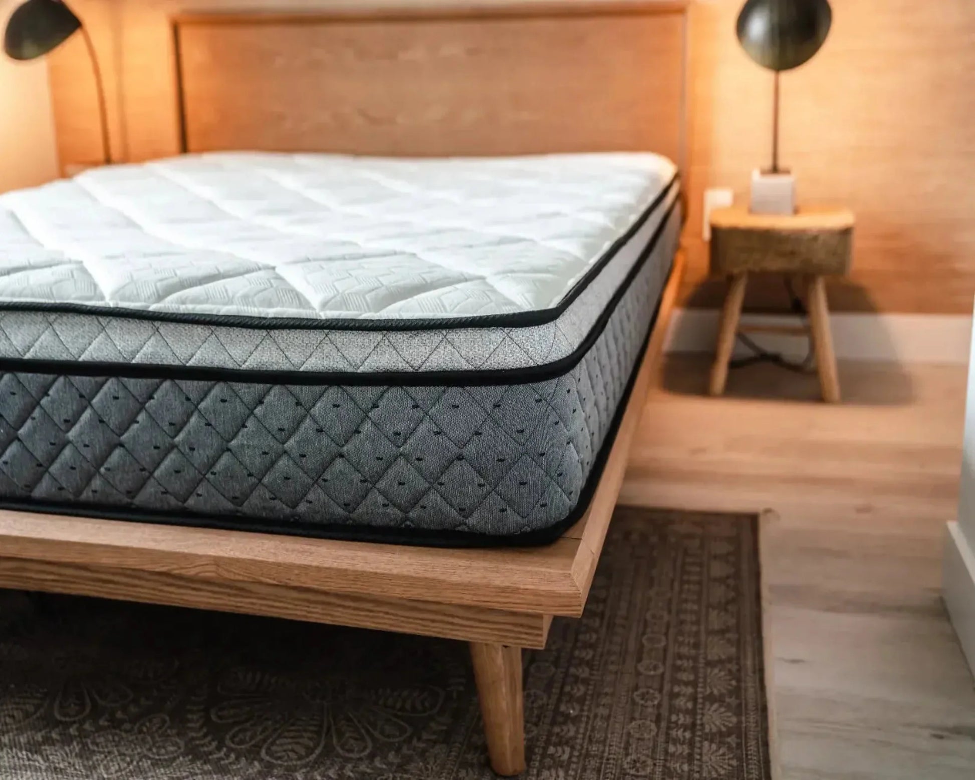 Mattress on a wooden bed frame in a bedroom setting