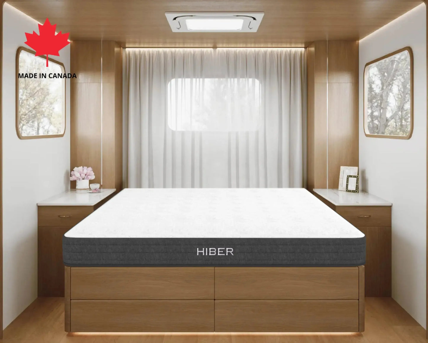 Hiber mattress in a modern bedroom setting with wooden furniture and a window.