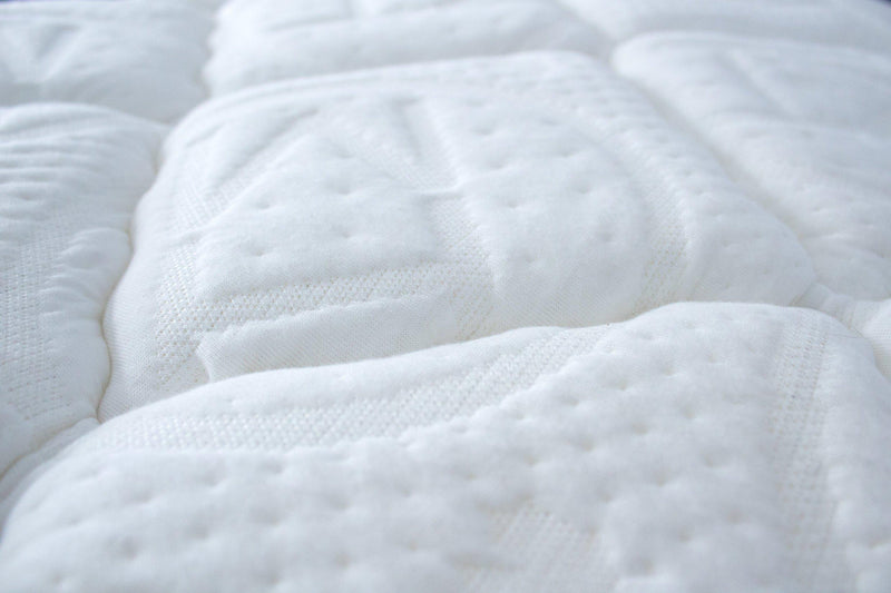 close up of Haven Mattress Soft Comfort Mattress topped with embossed Haven Logo