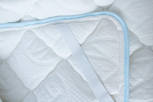 Close up Haven Soft Comfort topper with light blue edging and embossed Haven logo