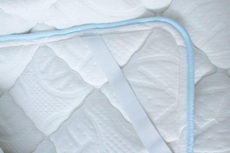 Close up Haven Soft Comfort topper with light blue edging and embossed Haven logo